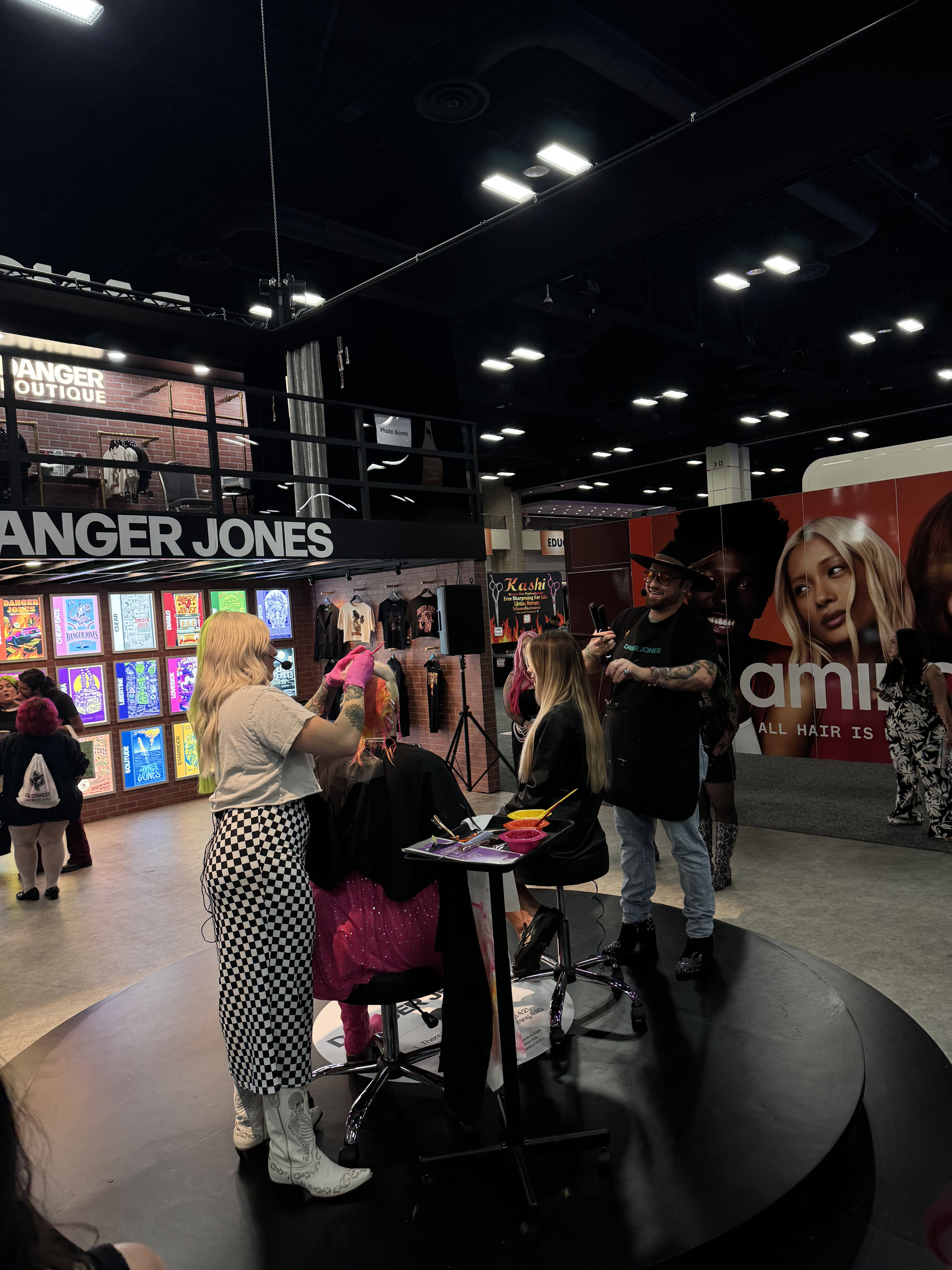 Black and white portrait of a dance instructor posing in front of a dark background.