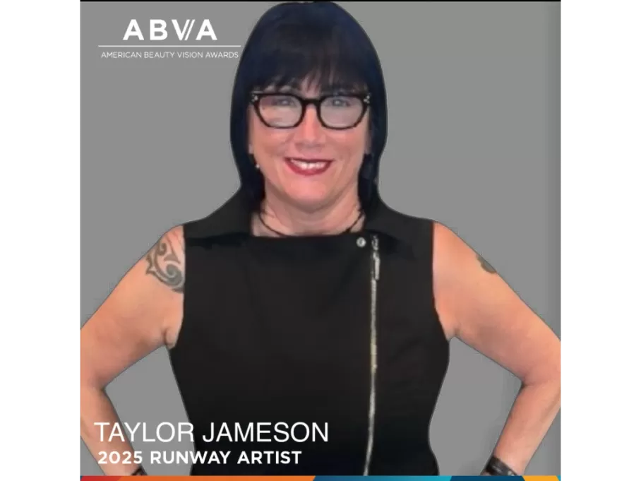 Black and white portrait of a dance instructor posing in front of a dark background.