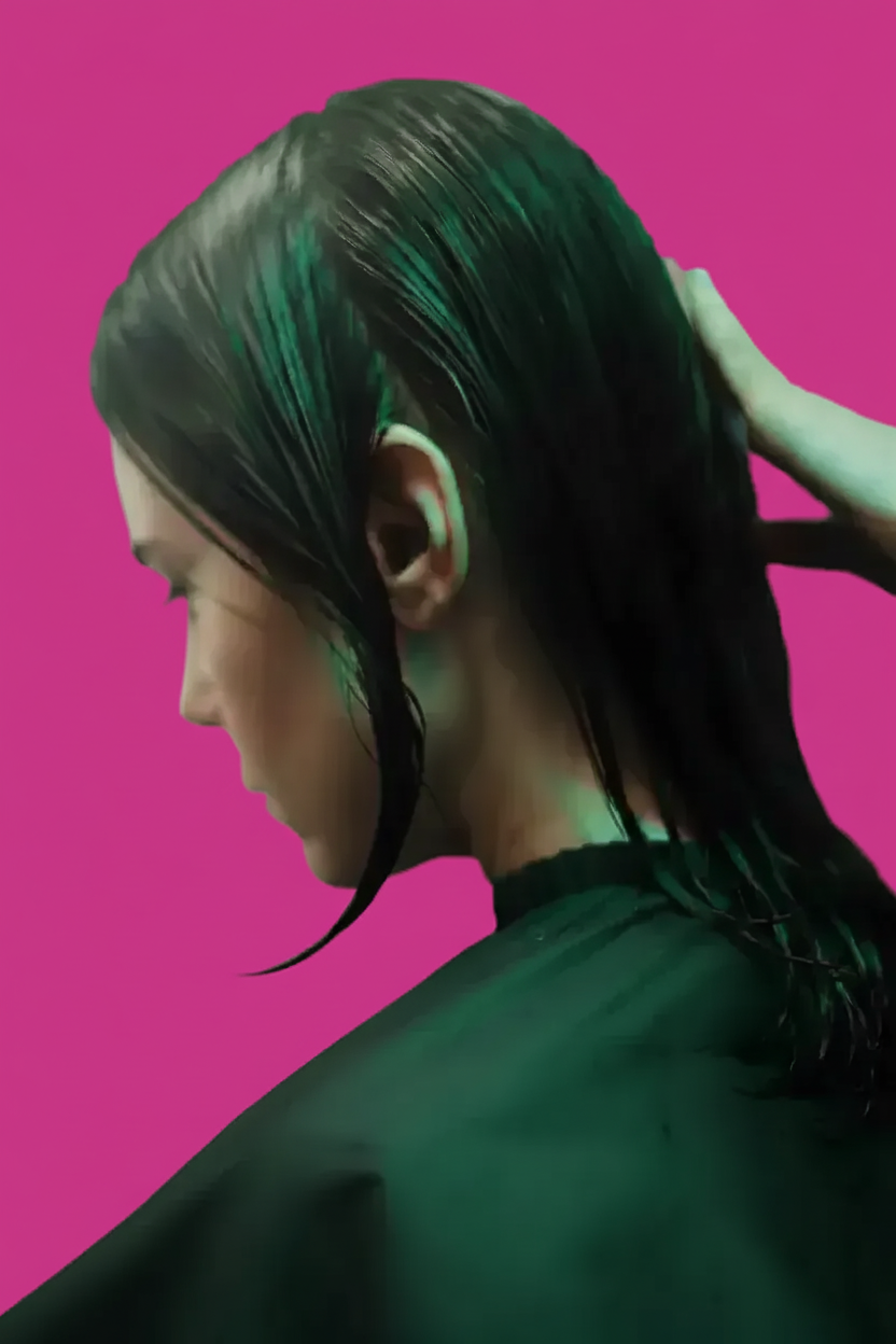 Black and white photo of a women performing modern dance on a dark background.