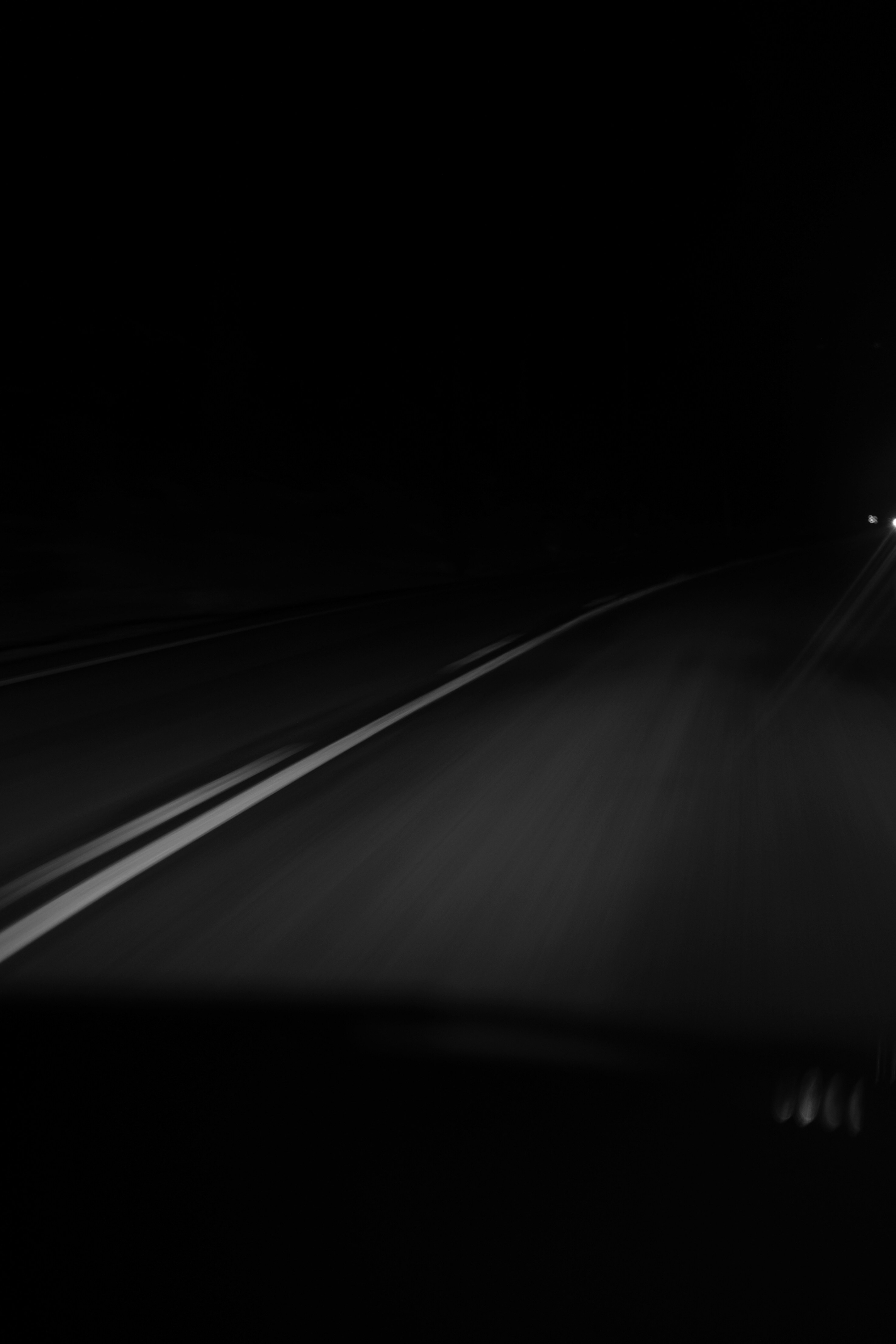 Black and white photo of teens rehearsing a dance routine on a stage.